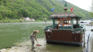 Sweeping the entrance to the fähre of Engelhartszell